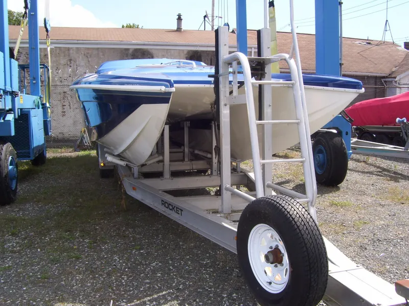 Slide: The Image of 2002 Mares 38 High Performance boat on trailer, parked outdoors. - 5