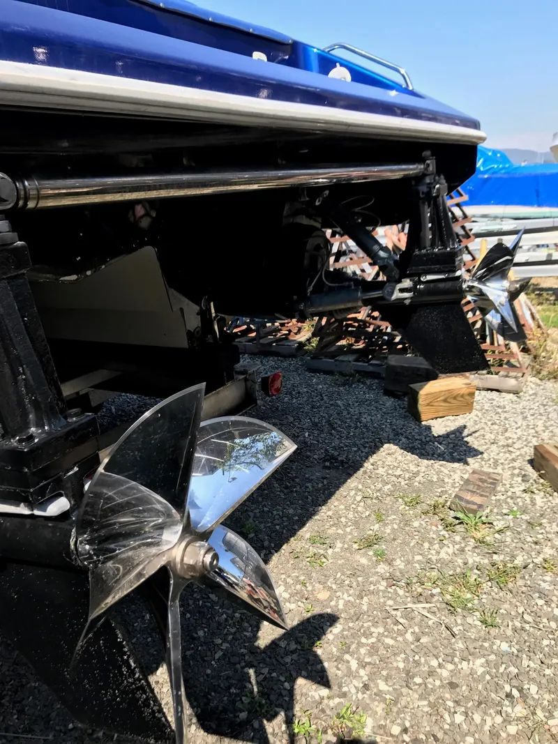 Slide: The Image of 2002 Mares 38 High Performance boat with dual propellers on gravel. - 6