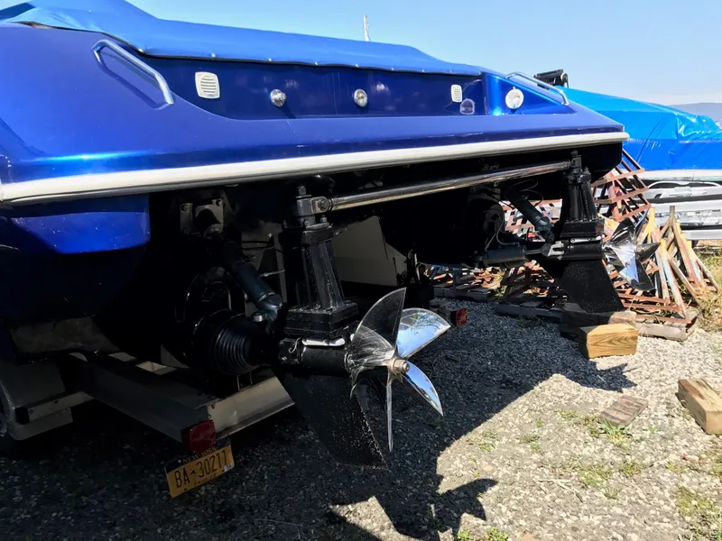 Slide: The Image of 2002 Mares 38 High Performance boat with dual propellers, parked on gravel. - 7