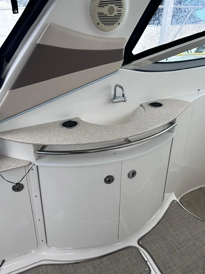Slide: The Image of 2007 Chaparral 350 Signature boat interior with countertop, sink, and storage cabinets. - 13