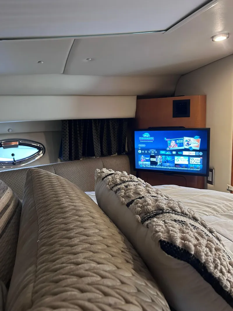 Slide: The Image of Interior of 2007 Chaparral 350 Signature yacht with cozy bedding and a flat-screen TV. - 22