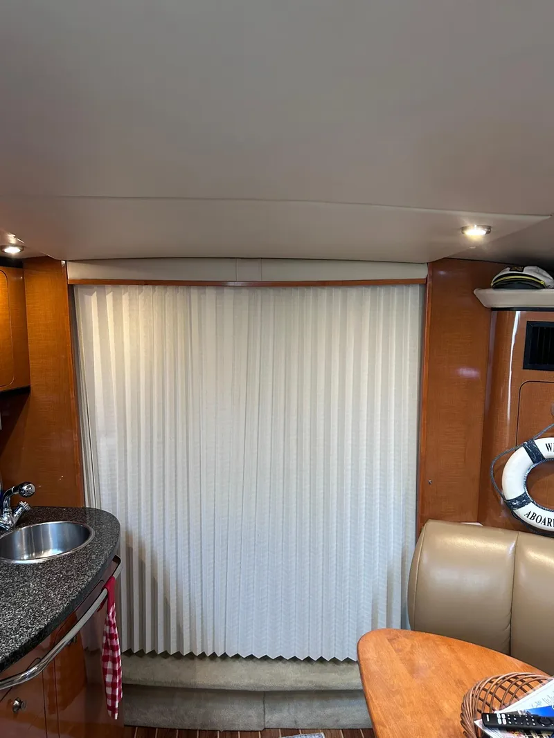 Slide: The Image of Interior of a 2007 Chaparral 350 Signature yacht with kitchenette and seating area. - 23