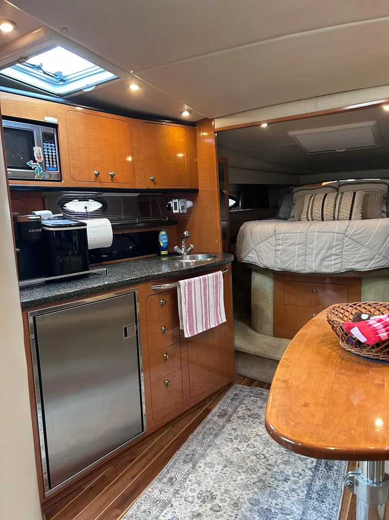 Slide: The Image of 2007 Chaparral 350 Signature yacht interior with kitchenette, bed, and dining area. - 26