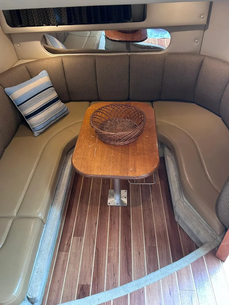 Slide: The Image of 2007 Chaparral 350 Signature interior with cozy seating, wooden table, and decorative pillow. - 31