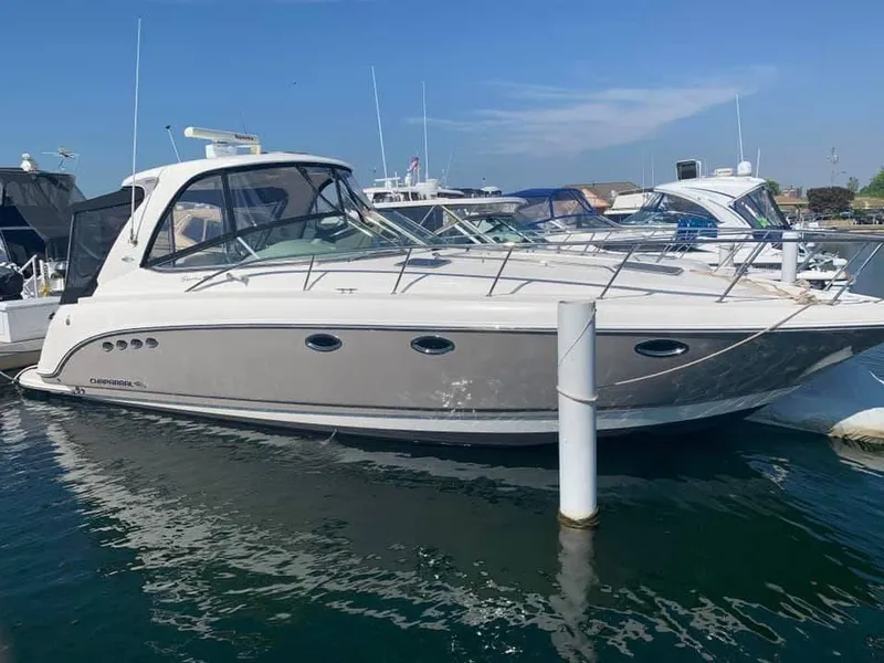 Slide: The Image of 2007 Chaparral 350 Signature boat docked in a marina under clear blue skies. - 4