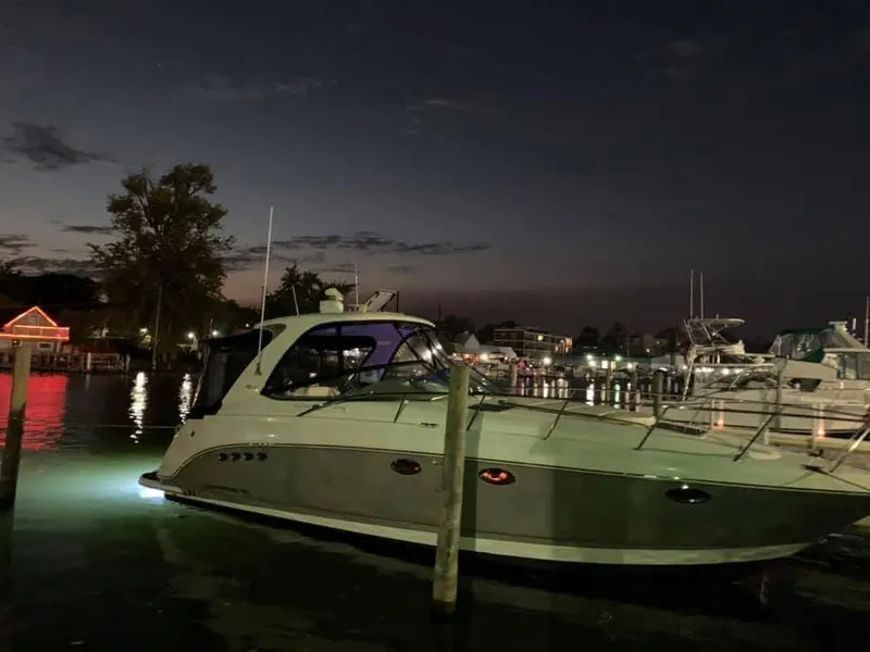 Slide: The Image of 2007 Chaparral 350 Signature yacht docked at night, illuminated by marina lights. - 5