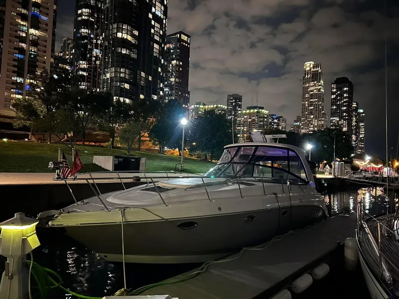 Slide: The Image of 2007 Chaparral 350 Signature yacht docked at night, city skyline in background. - 6