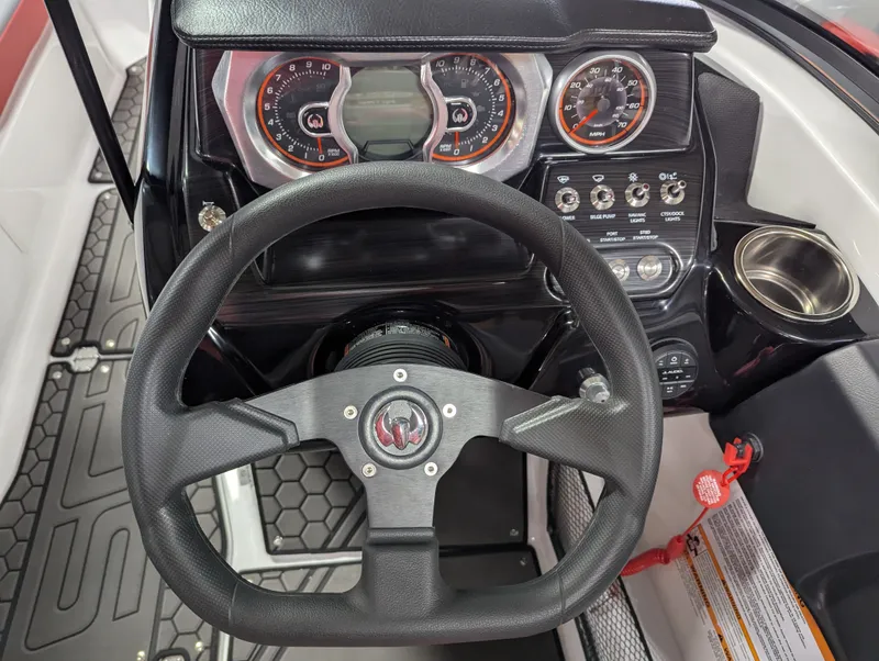 Slide: The Image of Steering wheel and dashboard of the 2025 Scarab 215LX boat. - 7