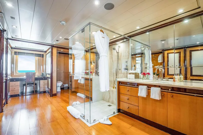 Slide: The Image of Luxurious yacht bathroom with glass shower, wooden flooring, and elegant vanity. Amels Oceangoing 2004. - 10