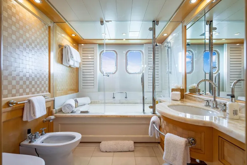 Slide: The Image of Luxurious yacht bathroom with elegant fixtures, glass shower, and ocean view windows on Amels Oceangoing 2004. - 18