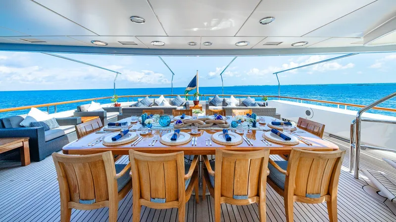 Slide: The Image of Luxurious 2004 Amels Oceangoing yacht deck with elegant dining setup and ocean view. - 25