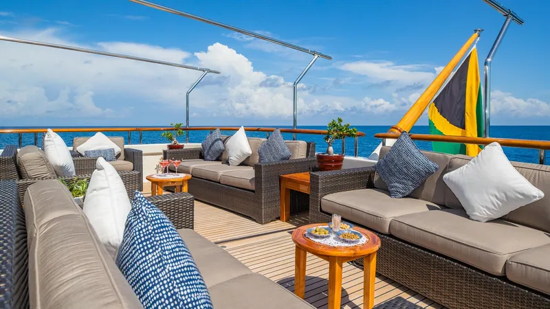 Slide: The Image of Luxurious 2004 Amels Oceangoing yacht deck with plush seating and ocean view. - 27