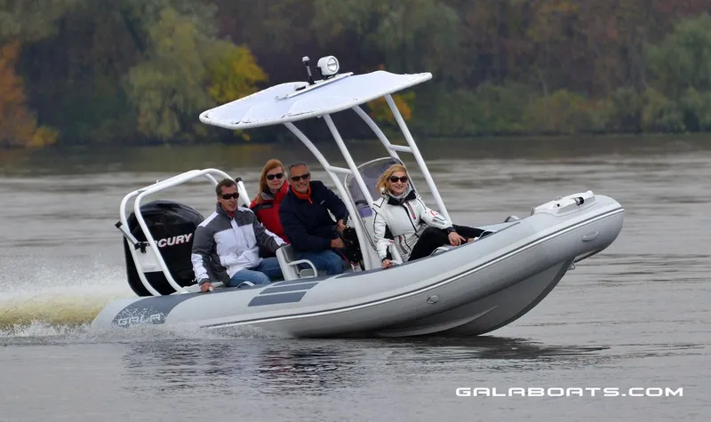 Slide: The Image of 2024 Gala VIKING V500 boat cruising on a lake with four passengers. - 10