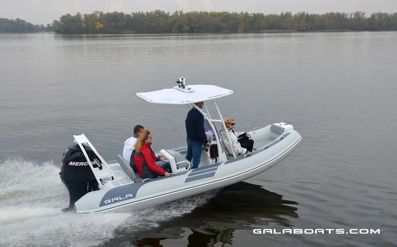 Slide: The Image of 2024 Gala VIKING V500 boat cruising on a calm lake with passengers. - 7