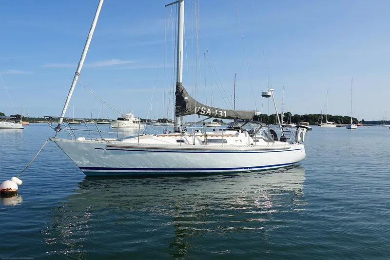 Slide: The Image of Sailboat Nordic 40, 1989 model, anchored on calm water under clear blue sky. - 1