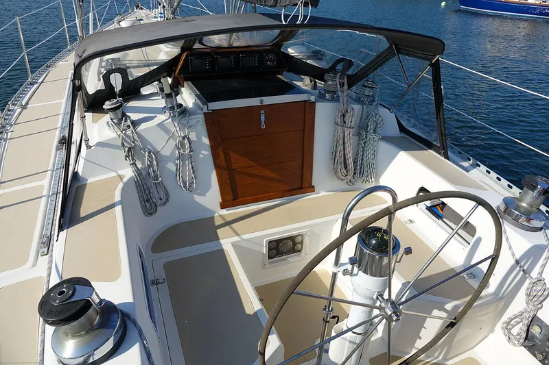 Slide: The Image of Cockpit of a 1989 Nordic 40 sailboat with steering wheel and ropes. - 10