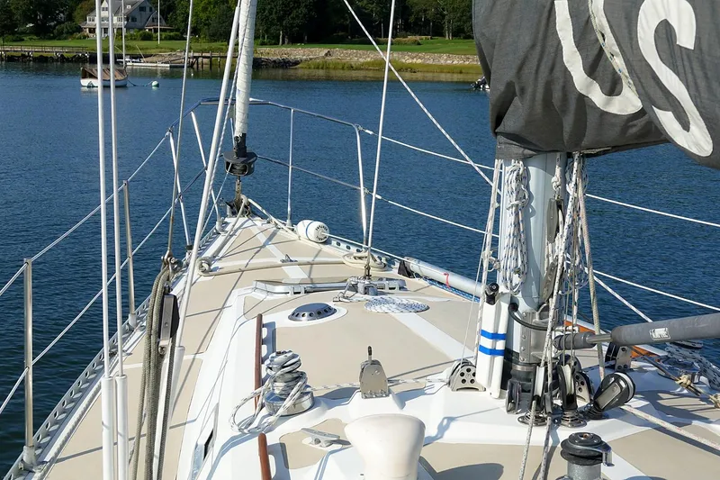 Slide: The Image of Sailboat deck view, Nordic 40 model, 1989, on calm water near shoreline. - 12