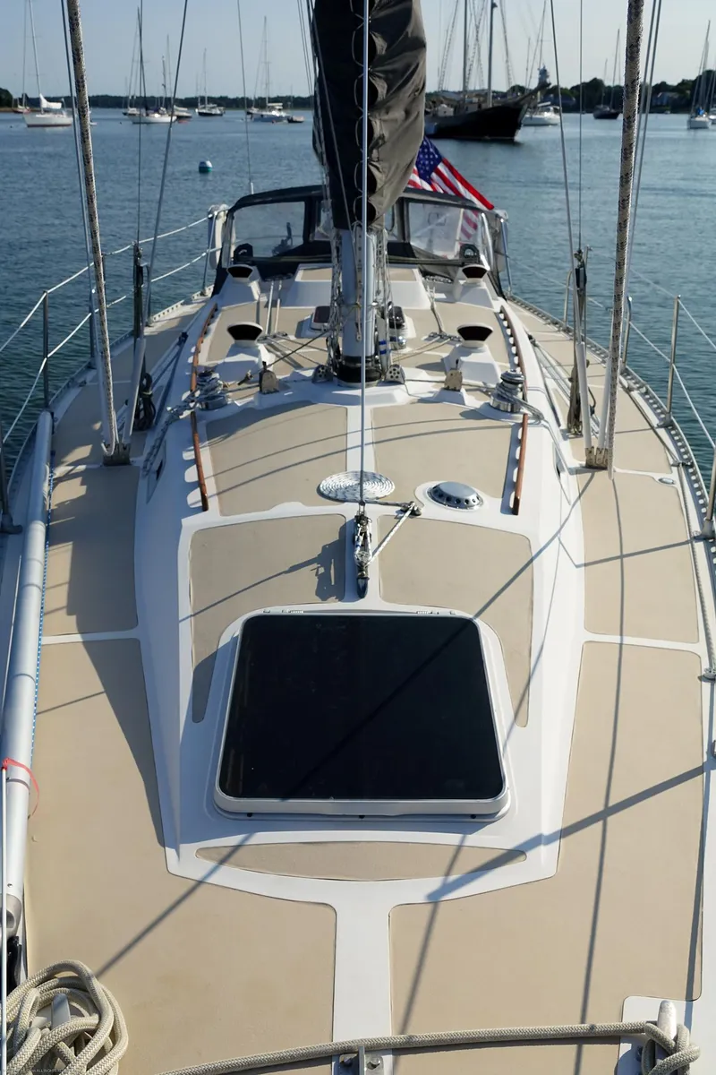 Slide: The Image of 1989 Nordic 40 sailboat deck with rigging, docked in a marina. - 14