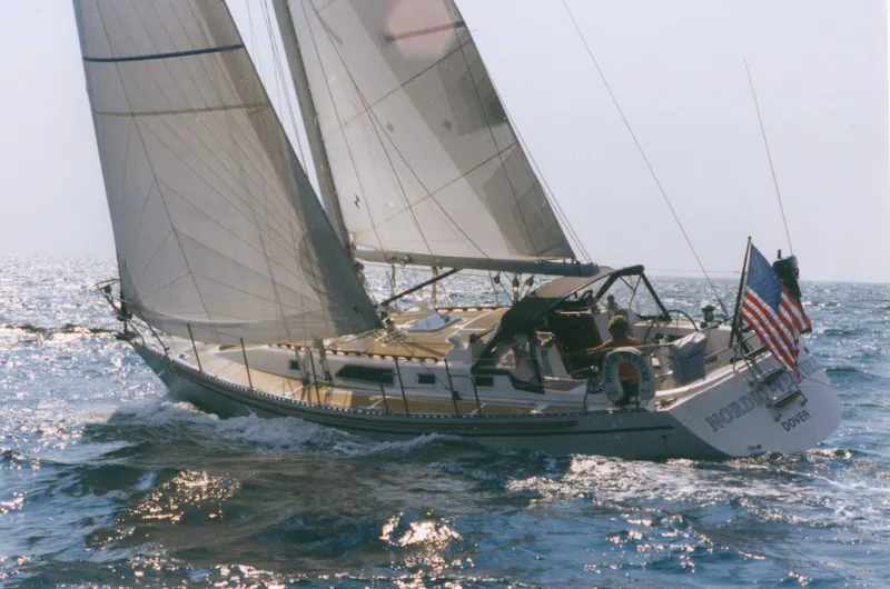 Slide: The Image of Sailing yacht Nordic 40 from 1989 navigating ocean waters with full sails. - 18