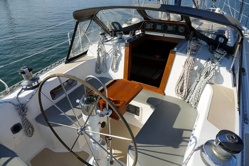 Slide: The Image of Cockpit of 1989 Nordic 40 sailboat with steering wheel and ropes. - 21