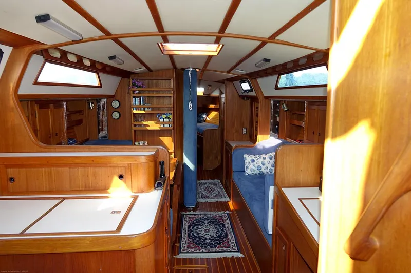 Slide: The Image of Interior of 1989 Nordic 40 sailboat with wooden furnishings and cozy seating areas. - 23