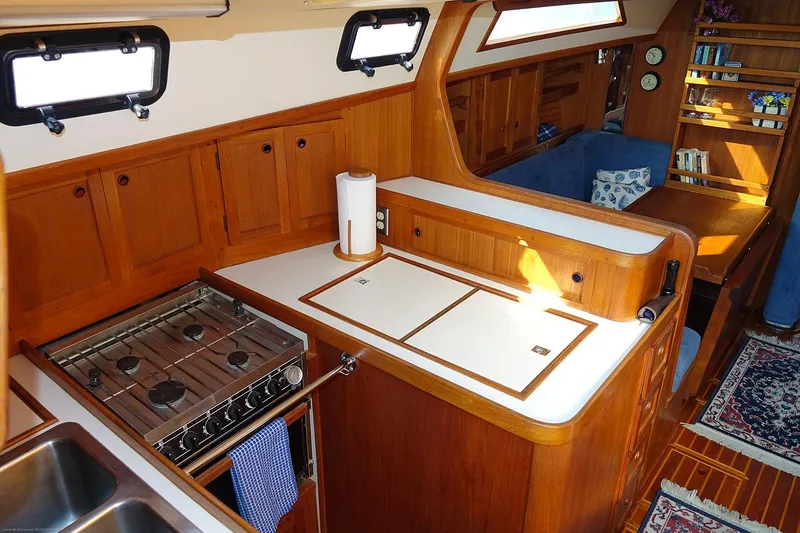 Slide: The Image of Interior of 1989 Nordic 40 yacht with wooden cabinetry and compact kitchen area. - 25
