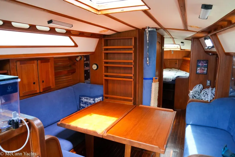 Slide: The Image of Interior of 1989 Nordic 40 yacht with wooden furnishings and blue seating. - 28