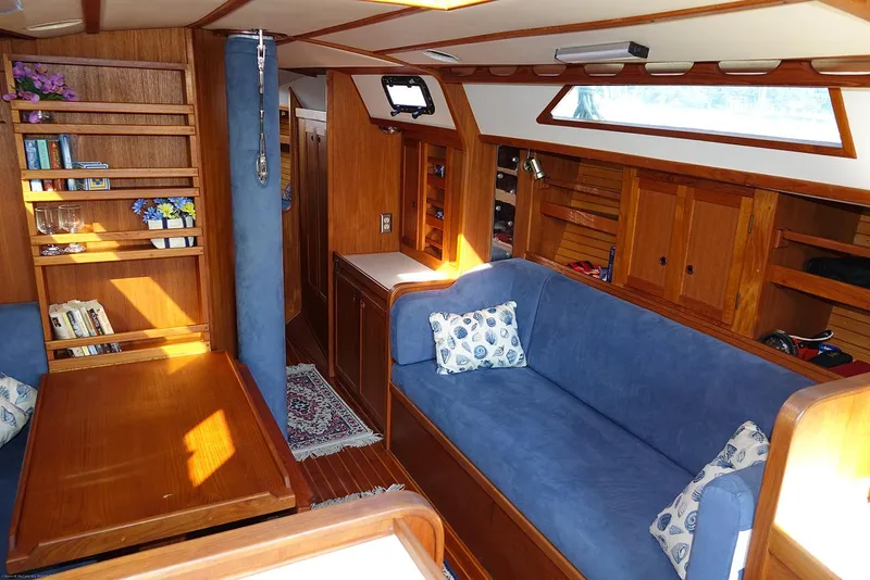 Slide: The Image of Cozy interior of a 1989 Nordic 40 sailboat with blue seating and wooden accents. - 33