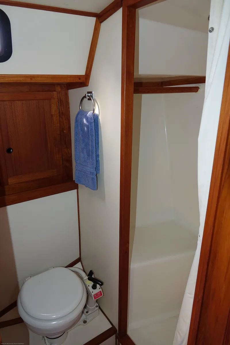 Slide: The Image of 1989 Nordic 40 yacht bathroom with wooden accents, shower, and towel rack. - 36