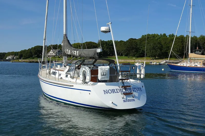 Slide: The Image of Sailboat Nordic 40, 1989 model, anchored in a serene harbor setting. - 4
