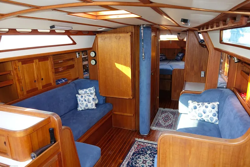 Slide: The Image of Interior of 1989 Nordic 40 sailboat with wooden finish and blue upholstery. - 48