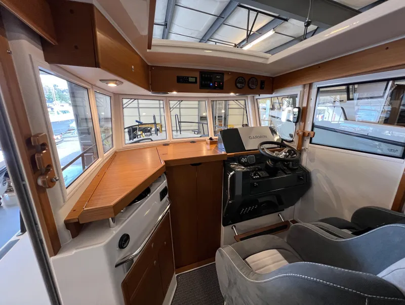Slide: The Image of Interior of 2024 Sargo 28 boat with modern helm and wooden accents. - 11