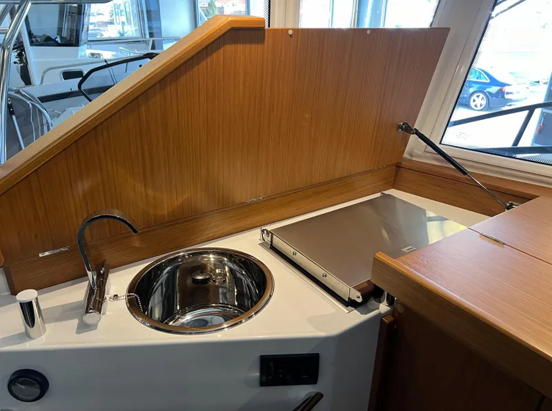 Slide: The Image of Compact kitchen area in 2024 Sargo 28 boat with sink and stove. - 13