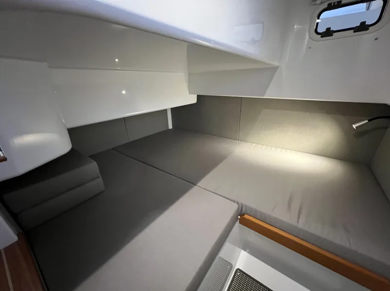 Slide: The Image of Interior cabin of 2024 Sargo 28 boat with grey cushions and modern lighting. - 23