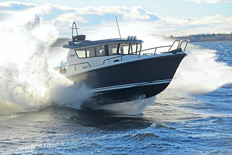 Slide: The Image of 2024 Sargo 28 boat cruising through waves on a sunny day. - 30