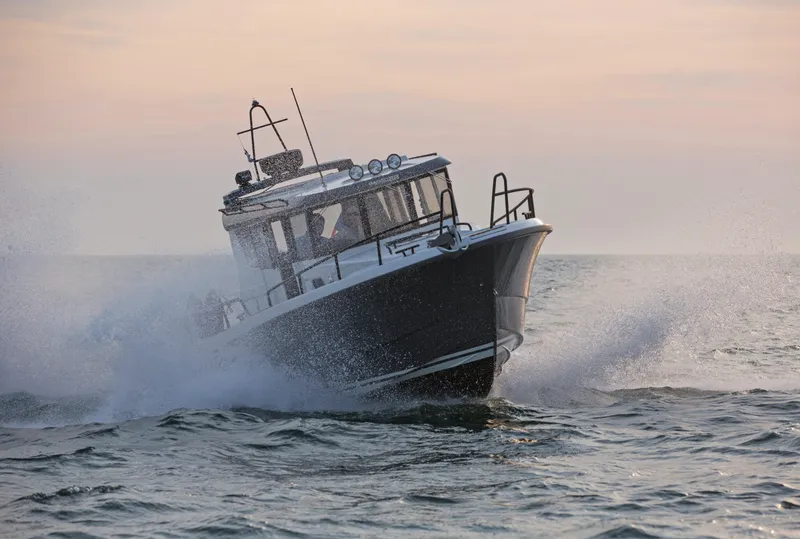 Slide: The Image of 2024 Sargo 28 boat cruising through waves at sunset. - 37