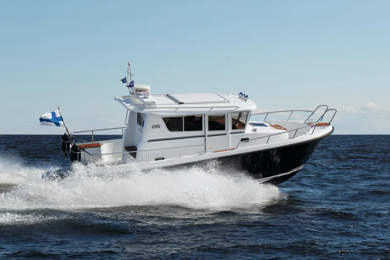 Slide: The Image of 2024 Sargo 28 boat cruising on open water. - 38