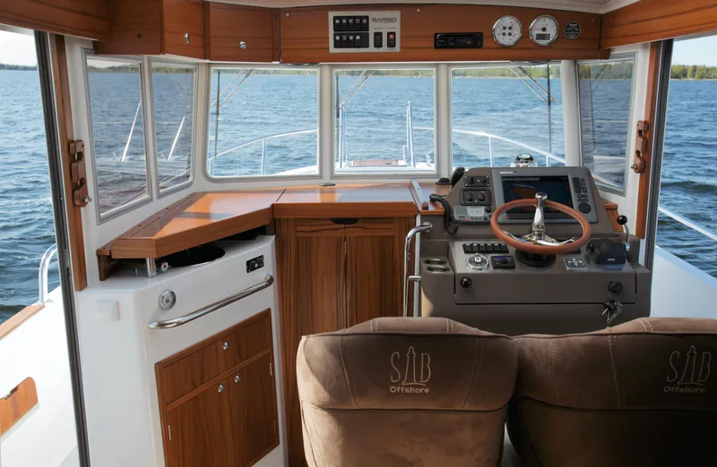 Slide: The Image of Interior cockpit of 2024 Sargo 28 boat with wooden accents and modern navigation equipment. - 42