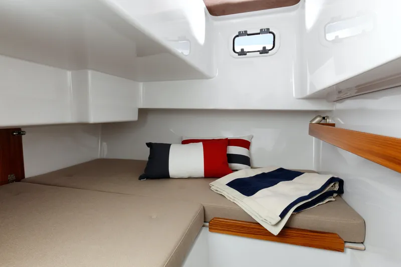 Slide: The Image of Cozy cabin interior of 2024 Sargo 28 boat with cushions and blankets. - 45