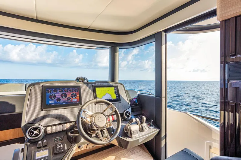 Slide: The Image of Helm of 2025 Absolute NAVETTA 52 yacht with ocean view and modern navigation equipment. - 10