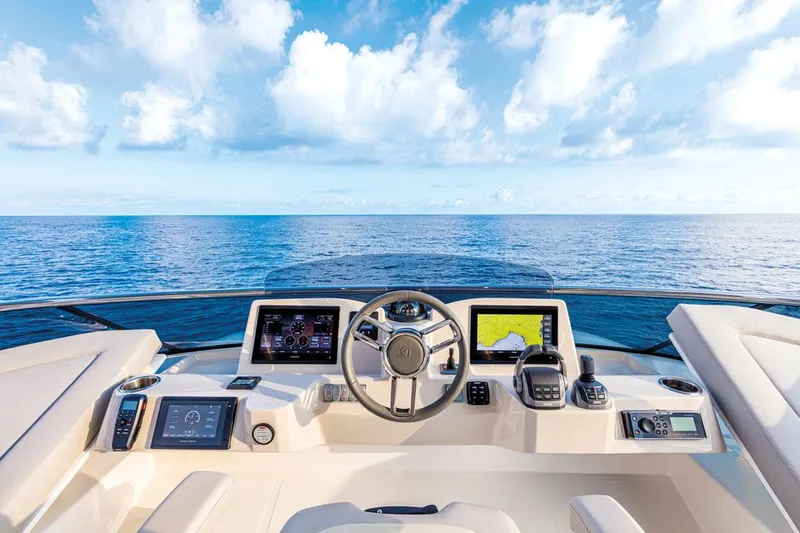 Slide: The Image of Cockpit view of 2025 Absolute NAVETTA 52 yacht with ocean horizon and blue sky. - 4