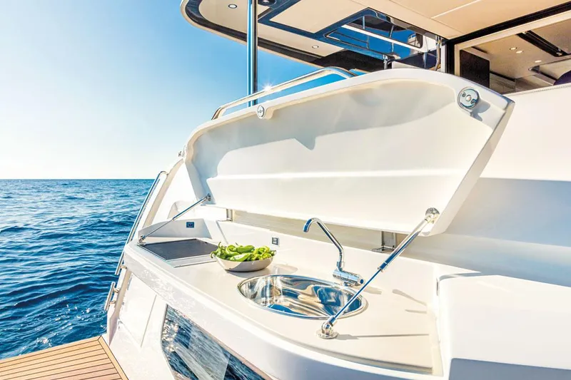 Slide: The Image of Luxury yacht Absolute NAVETTA 52, 2025 model, featuring an outdoor sink and countertop by the sea. - 7