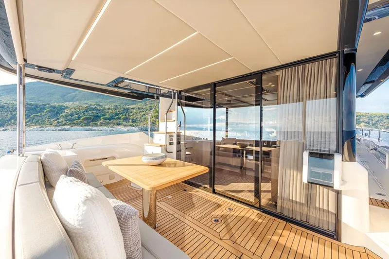Slide: The Image of Luxurious 2025 Absolute NAVETTA 52 yacht deck with elegant seating and scenic ocean view. - 8