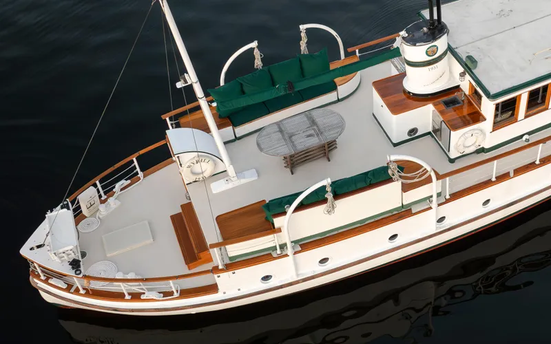 Slide: The Image of Aerial view of a 1931 Boeing Custom boat with green seating and wooden accents. - 14