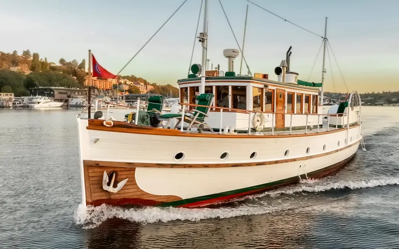 Slide: The Image of Vintage 1931 Boeing Custom yacht cruising on a scenic waterway. - 17