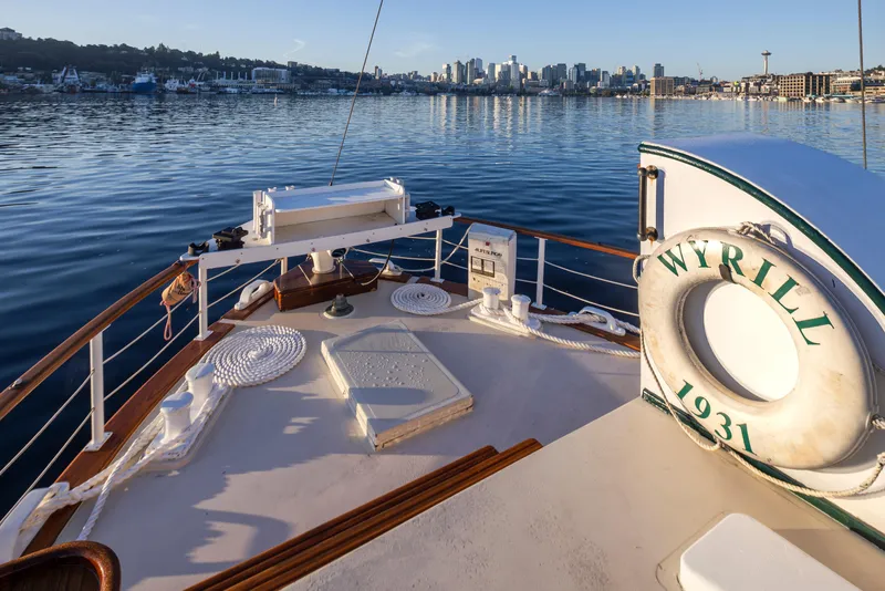 Slide: The Image of Deck of 1931 Boeing Custom boat "Wyrill" on calm water with city skyline. - 24