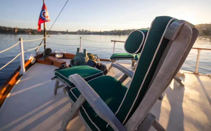 Slide: The Image of Luxurious deck chairs on a 1931 Boeing Custom yacht, overlooking serene waters at sunset. - 27