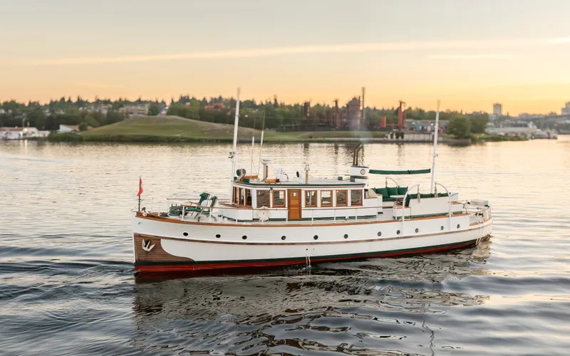 Slide: The Image of Vintage 1931 Boeing Custom yacht cruising on a serene lake at sunset. - 3