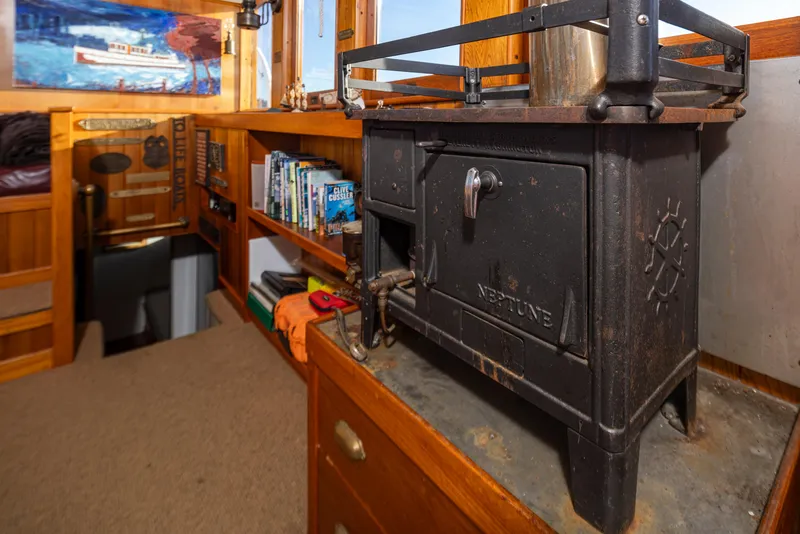 Slide: The Image of Vintage ship interior with a Neptune stove, wooden shelves, and nautical decor, Boeing Custom 1931. - 42
