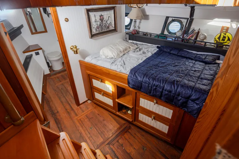 Slide: The Image of Cozy wooden cabin interior with bed, nautical decor, and porthole windows on a 1931 Boeing Custom. - 44